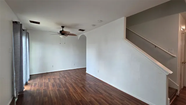 a view of a room with wooden floor and white walls