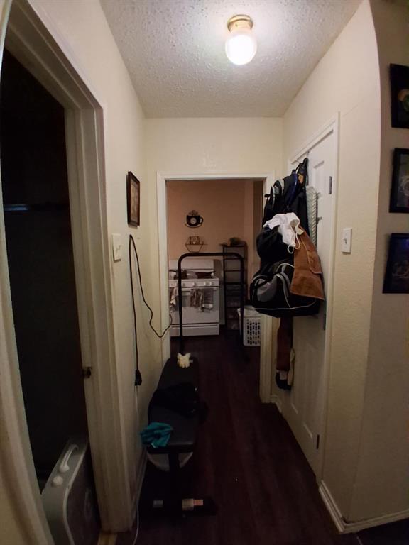 1015 East Morphy Street Fort Worth, TX 76104 - Photo 17 of 23 Corridor featuring a textured ceiling and dark wood-style flooring