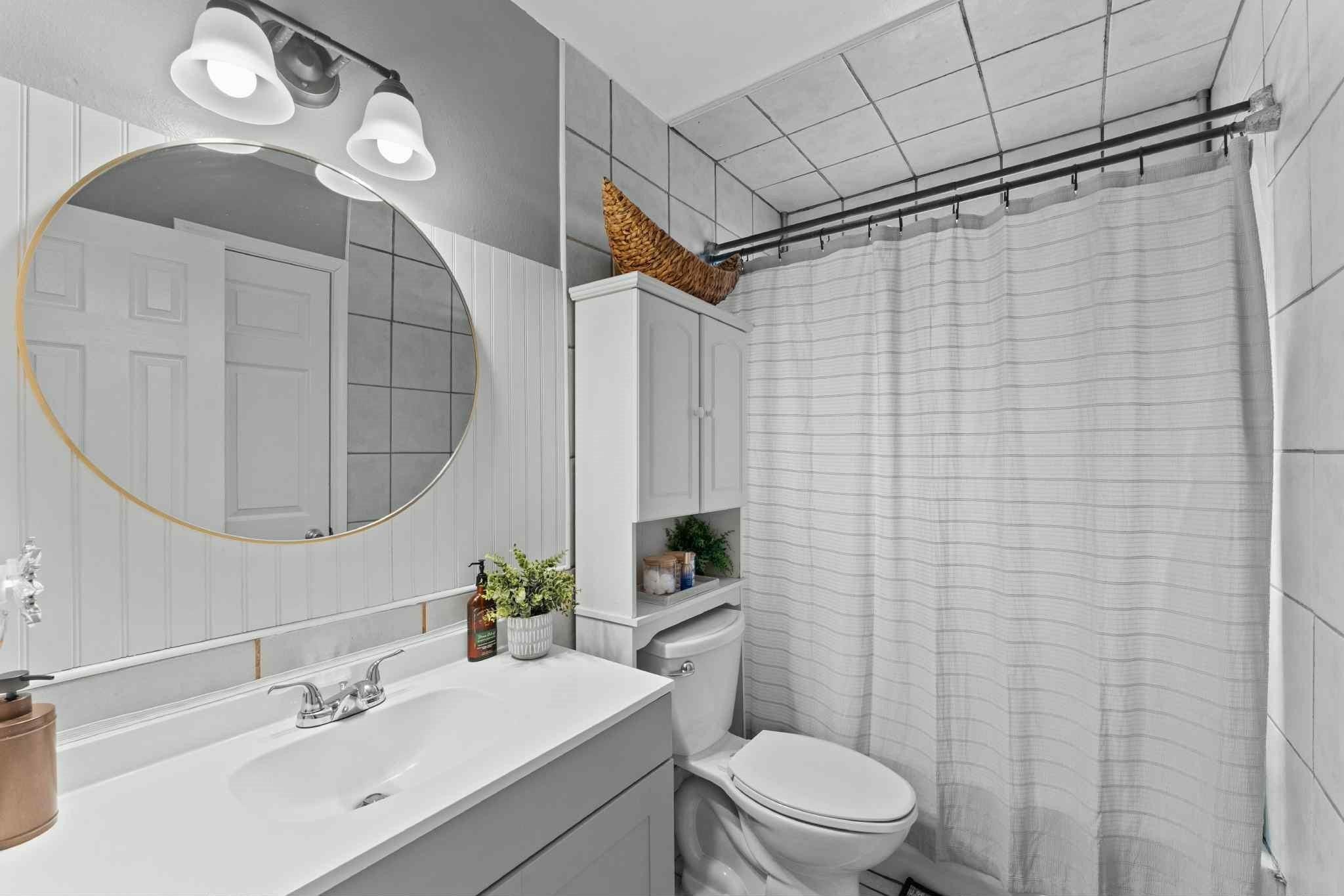 2102 North Pearland Avenue Pearland, TX 77581 - Photo 15 of 29 a bathroom with a sink a toilet and a mirror