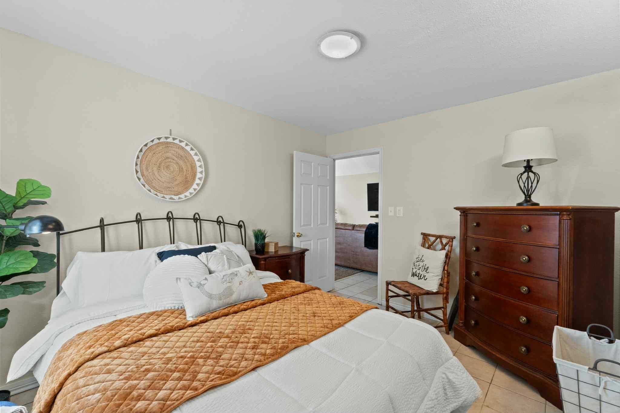 2102 North Pearland Avenue Pearland, TX 77581 - Photo 17 of 29 a bed room with a bed and a chandelier