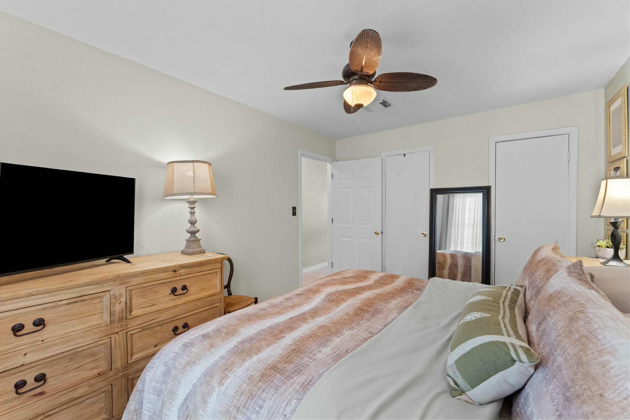 2102 North Pearland Avenue Pearland, TX 77581 - Photo 19 of 29 a bedroom with a bed and a flat screen tv