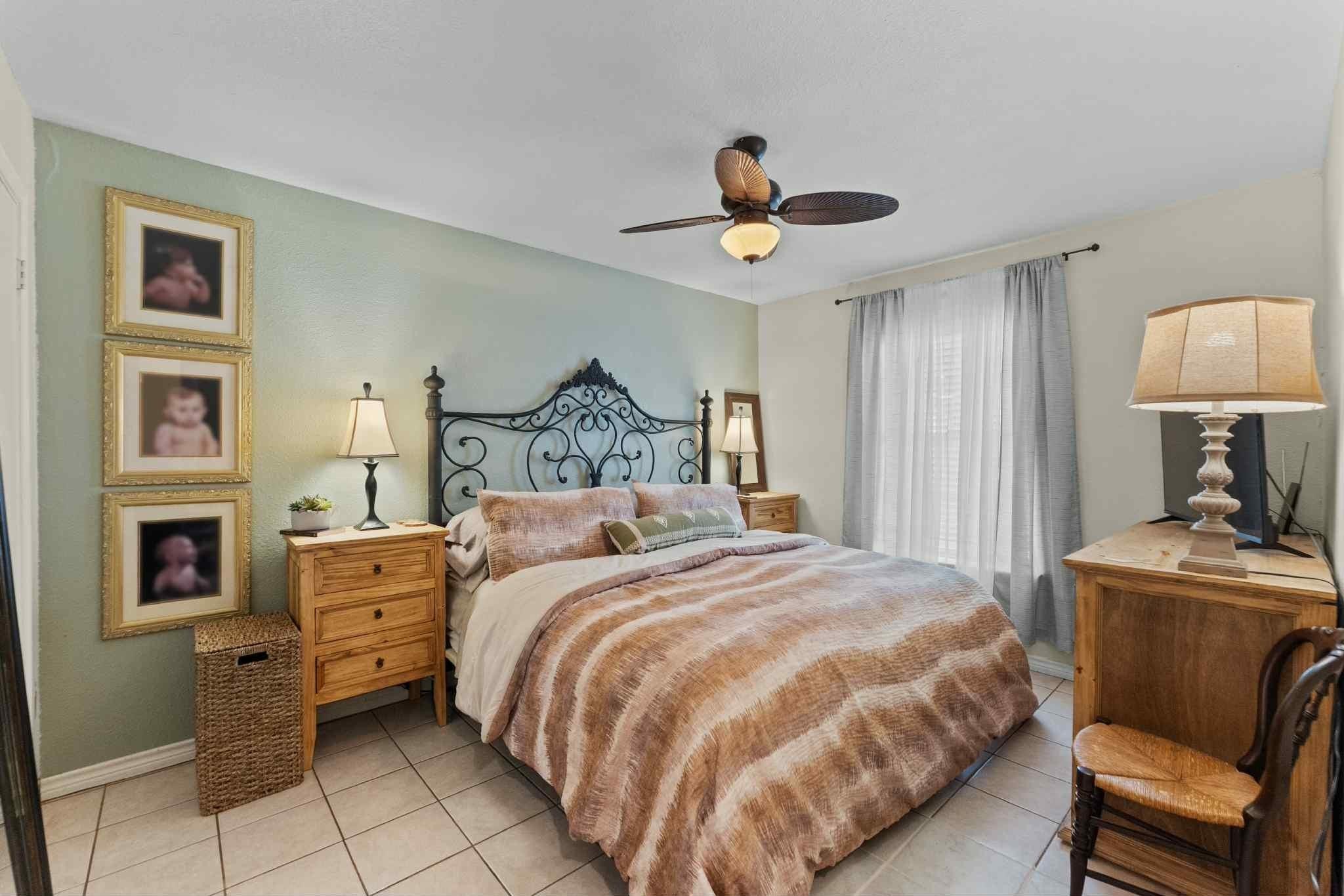2102 North Pearland Avenue Pearland, TX 77581 - Photo 20 of 29 a bedroom with a bed and a chandelier