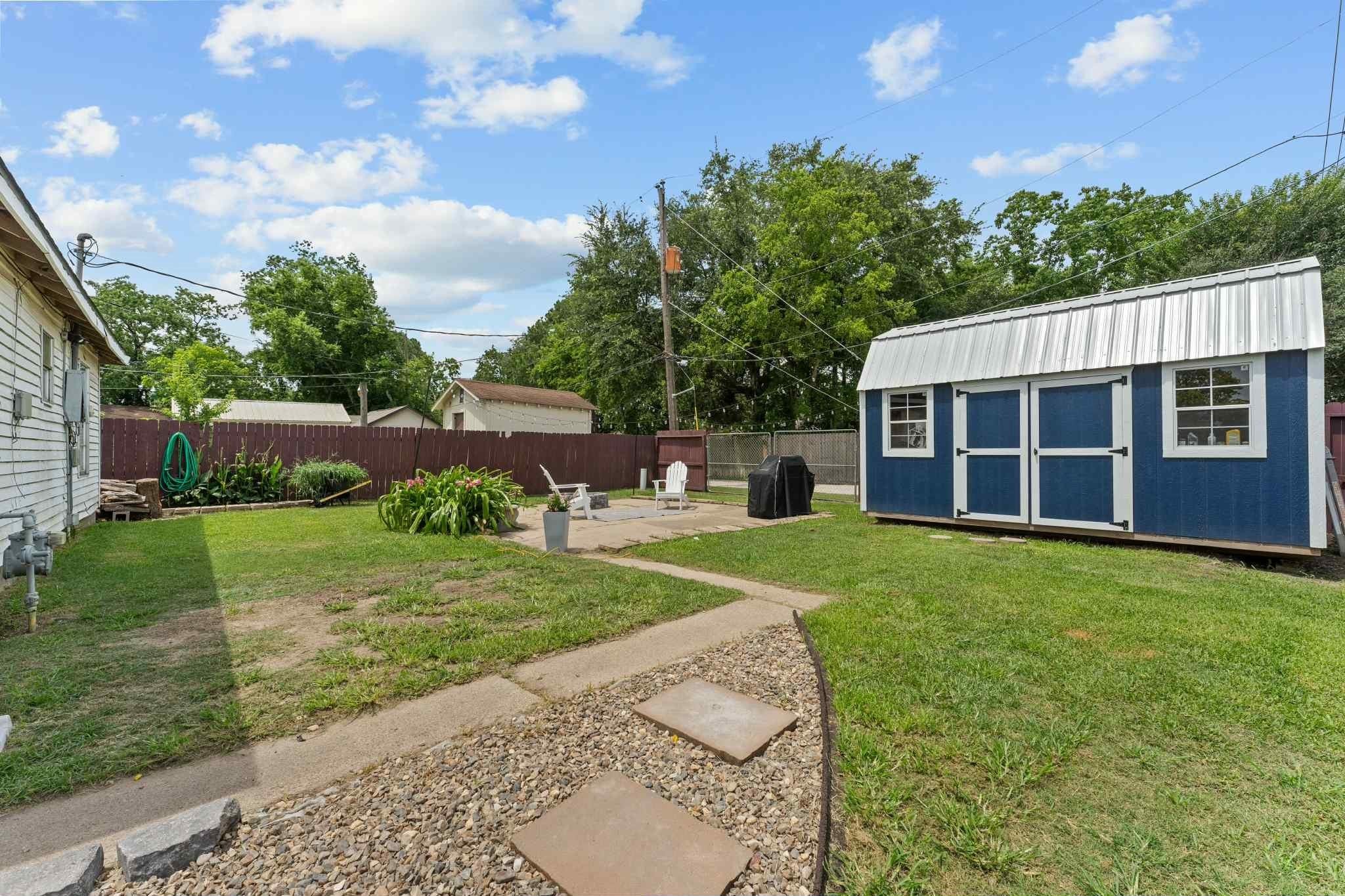 2102 North Pearland Avenue Pearland, TX 77581 - Photo 22 of 29 a view of a house with backyard and garden