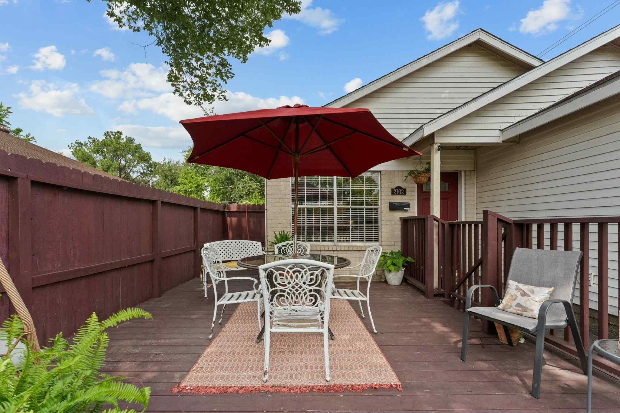 2102 North Pearland Avenue Pearland, TX 77581 - Photo 3 of 29 a patio with wooden floor a yard a table and chairs