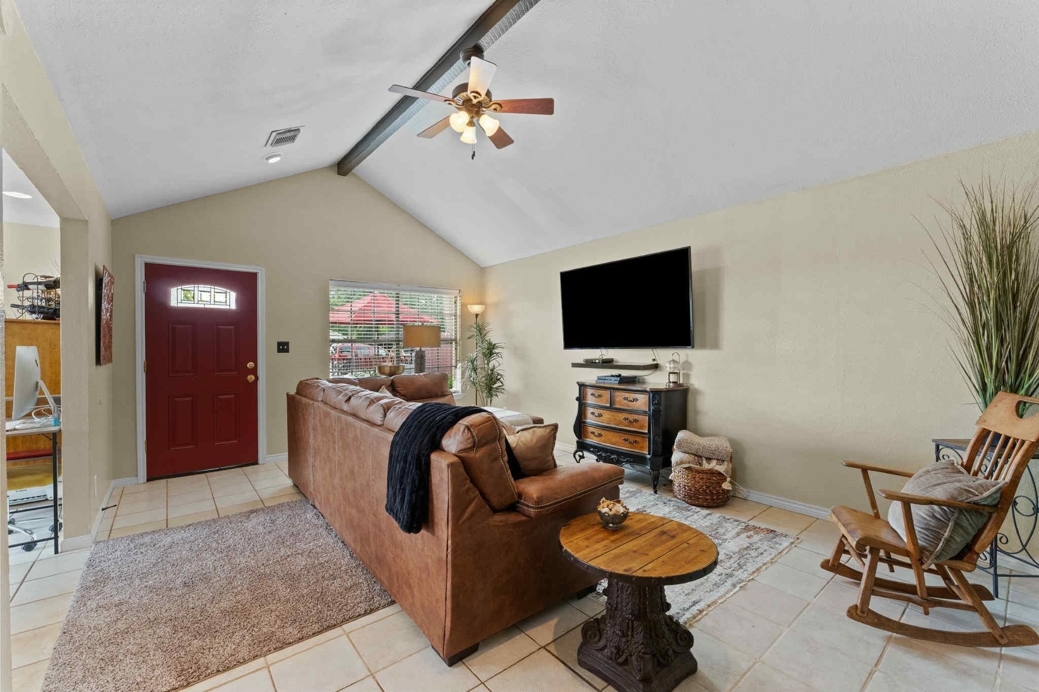 2102 North Pearland Avenue Pearland, TX 77581 - Photo 8 of 29 a living room with furniture a flat screen tv and kitchen view