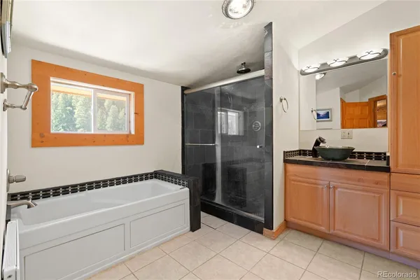 a spacious bathroom with a tub and shower