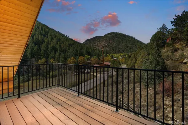 a view of balcony with wooden floor and fence