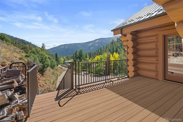 a view of a balcony with wooden floor and fence