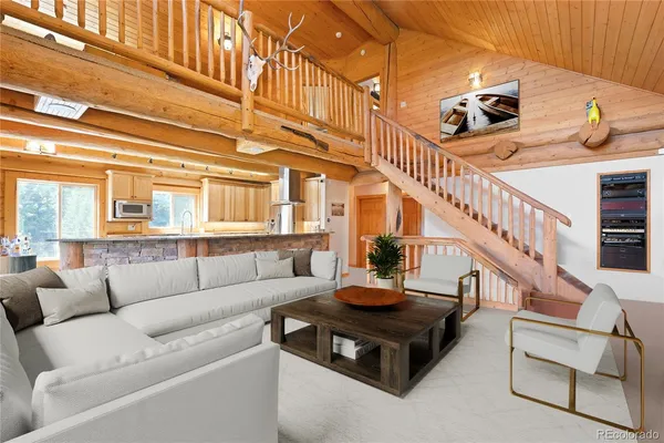 a living room with furniture and stairs