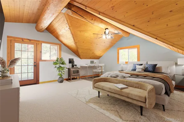 a bedroom with furniture and a large window