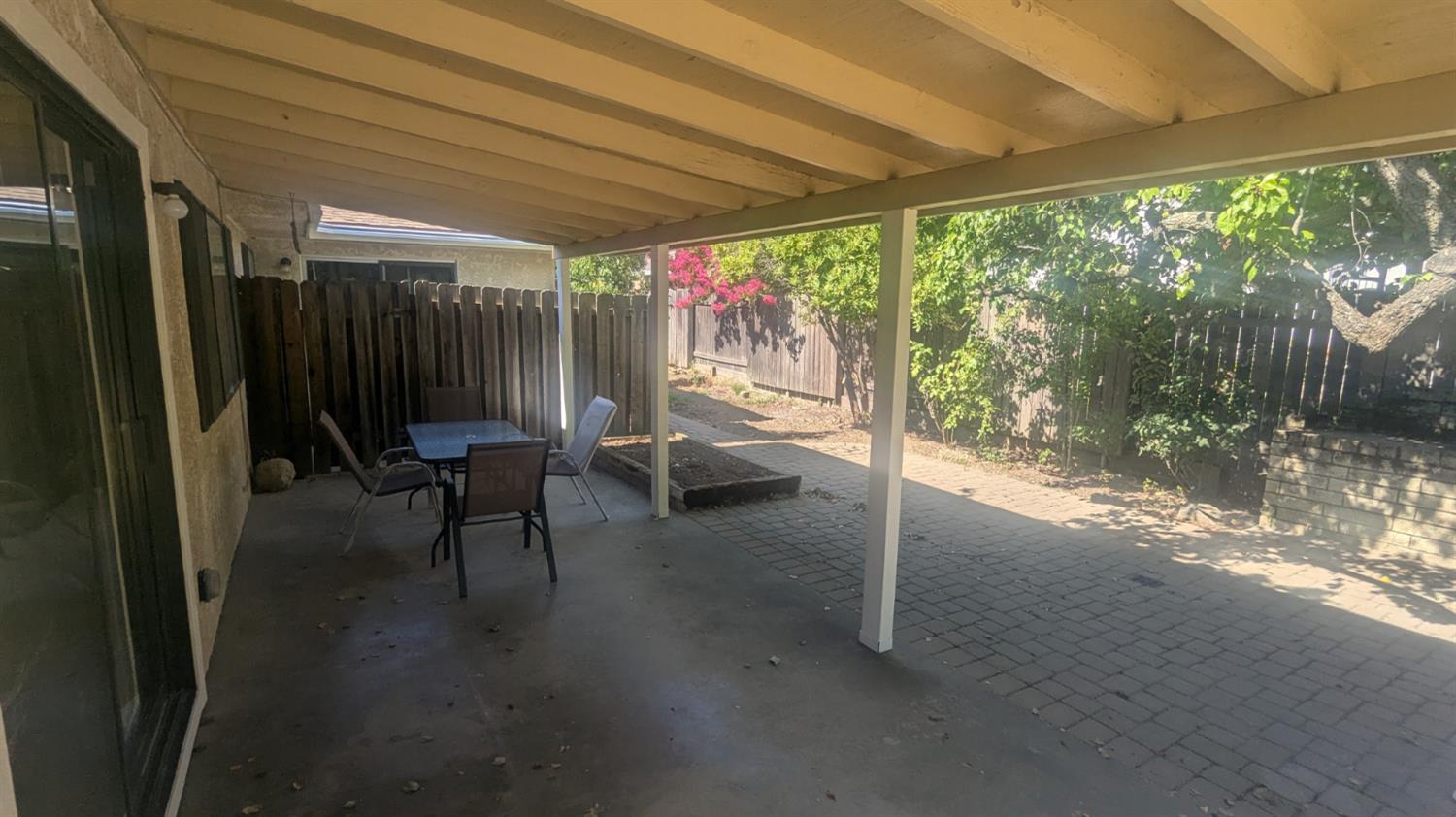 6851 Albury Street Citrus Heights, CA 95621 - Photo 19 of 22 a view of a porch with chairs and backyard next to a yard