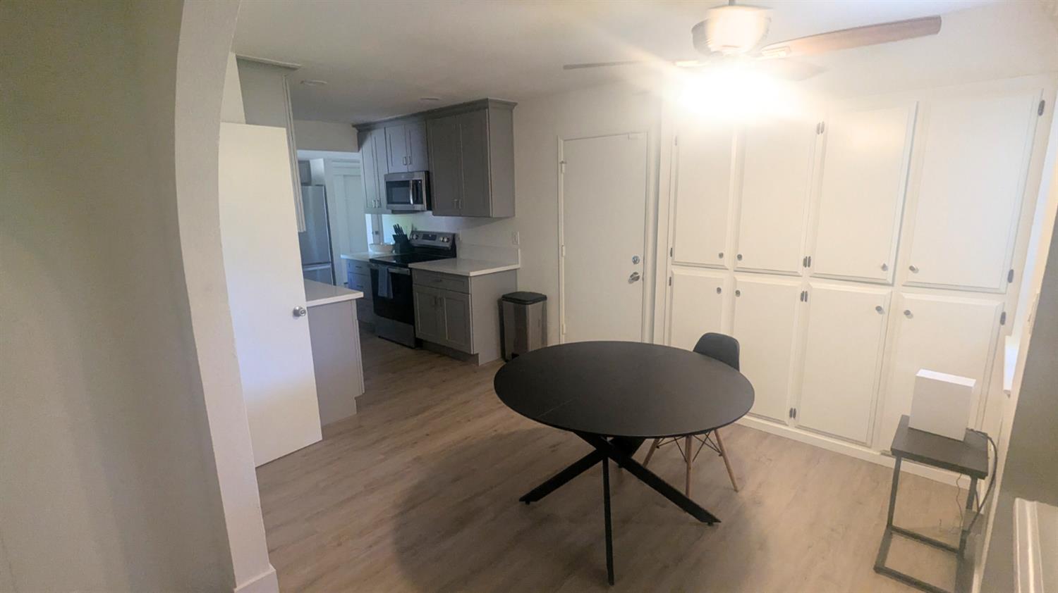6851 Albury Street Citrus Heights, CA 95621 - Photo 2 of 22 a kitchen with granite countertop a refrigerator a stove a sink and a dining table with wooden floor