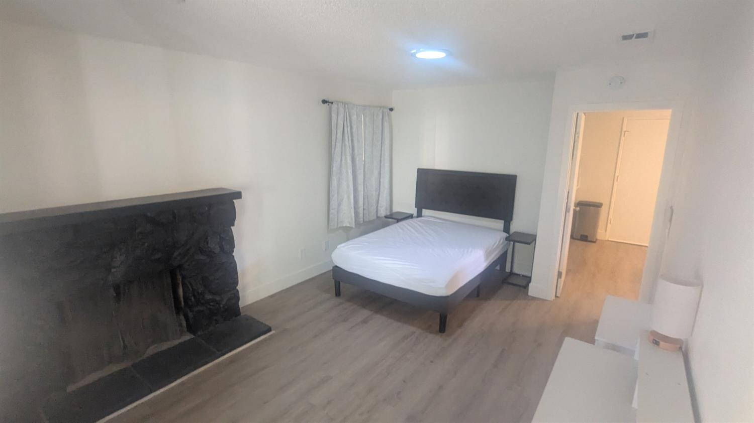 6851 Albury Street Citrus Heights, CA 95621 - Photo 9 of 22 a bedroom with a bed and wooden floor