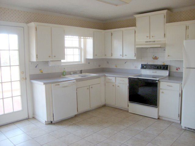 31 Anderson Road Forsyth, GA 31029 - Photo 3 of 8 a kitchen with cabinets appliances and a window
