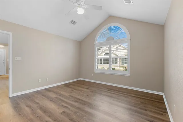 wooden floor in an empty room with a window