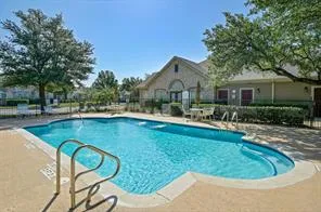a view of a house with swimming pool and sitting area