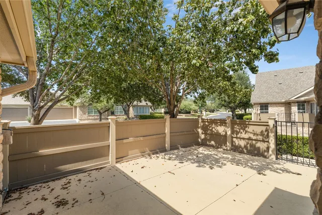 a view of a backyard with wooden fence