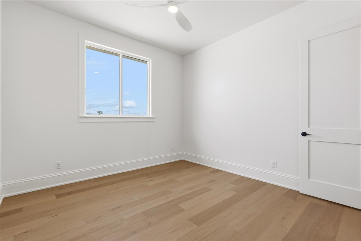 224 Sandia Loop Kingsland, TX 78639 - Photo 23 of 32 an empty room with wooden floor and windows