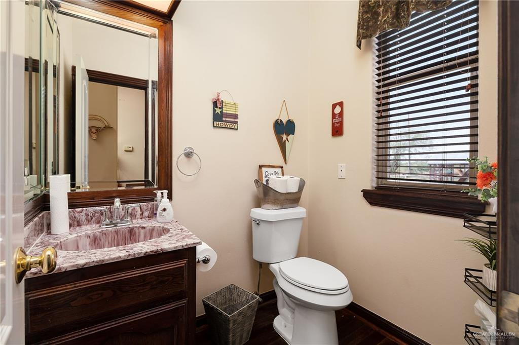23725 North Val Verde Road Edinburg, TX 78542 - Photo 16 of 36 a bathroom with a sink toilet and mirror