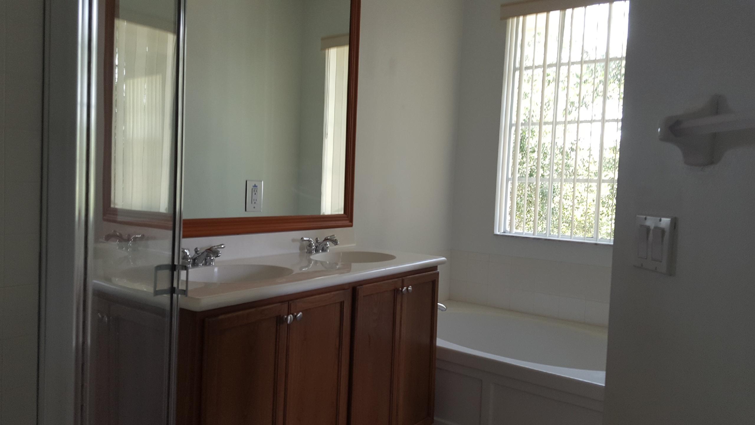 1865 Northwest 12th Street Boca Raton, FL 33431 - Photo 12 of 18 a bathroom with a granite countertop sink and mirror