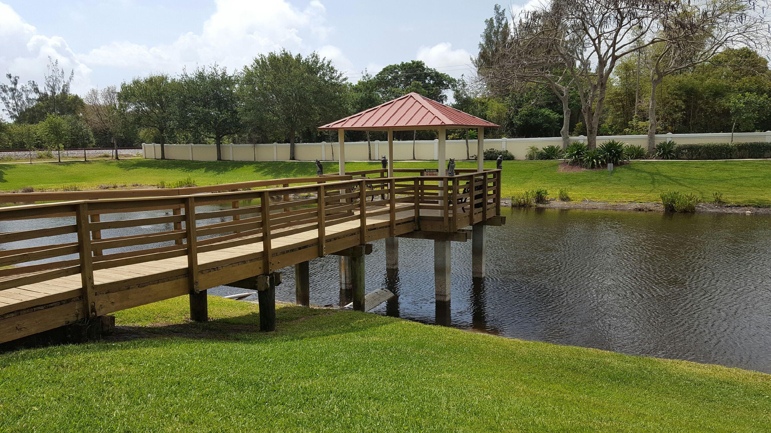 1865 Northwest 12th Street Boca Raton, FL 33431 - Photo 18 of 18 a view of a park with a bench and trees