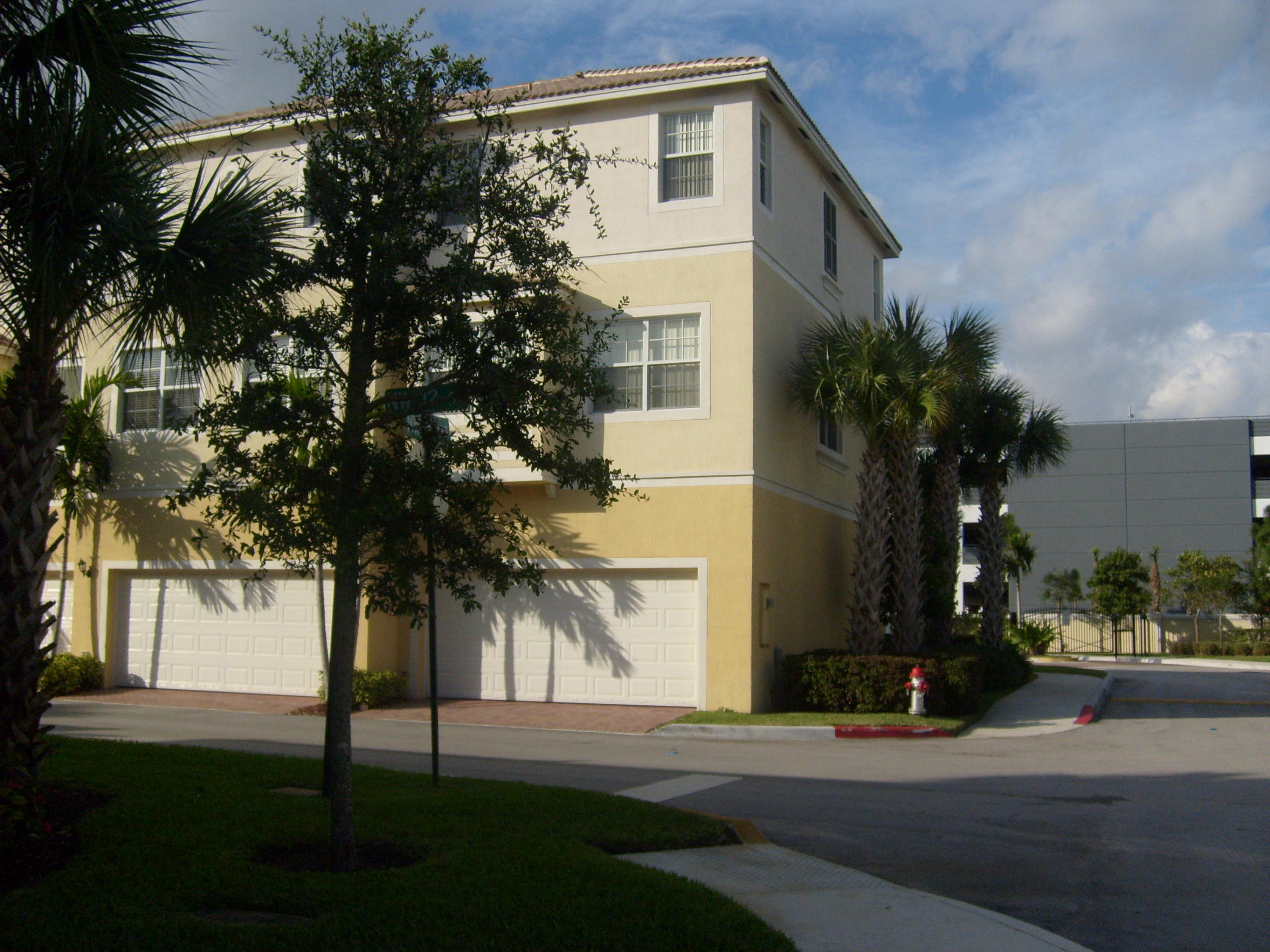 1865 Northwest 12th Street Boca Raton, FL 33431 - Photo 3 of 18 front view of house with a yard and trees