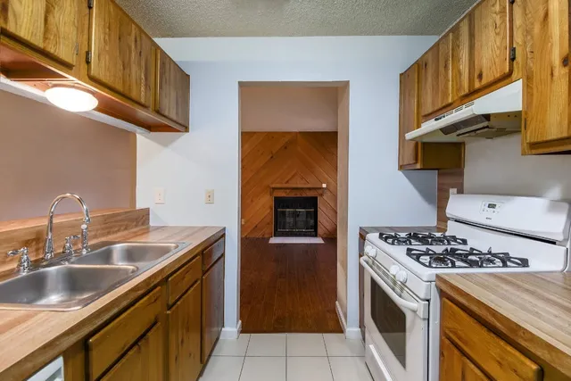 a kitchen with stainless steel appliances granite countertop a sink and a stove