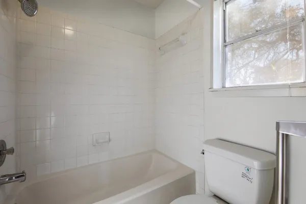 a bathroom with a bathtub and toilet