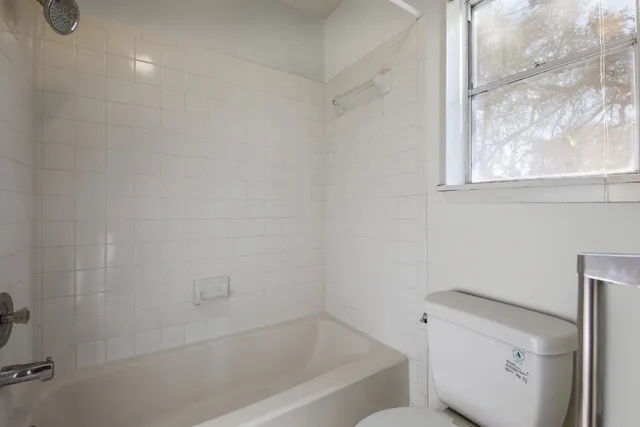 a bathroom with a bathtub and toilet