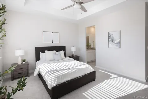 a bedroom with a bed lamp and a potted plant