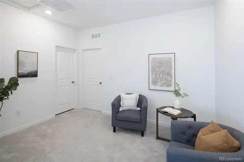 a living room with furniture and a potted plant