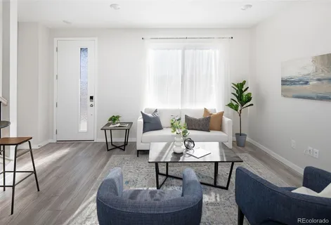 a living room with furniture and a potted plant