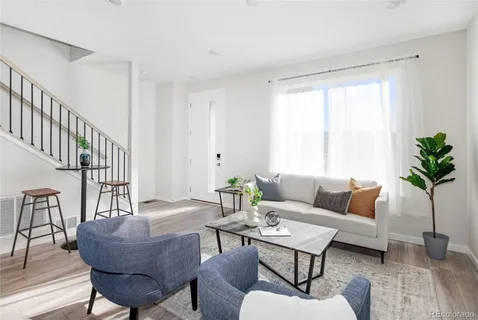 a living room with furniture and a potted plant