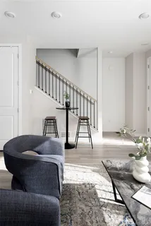 a living room with furniture and a dining table