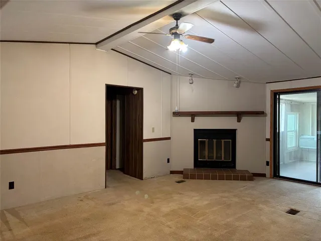 a view of a livingroom with an empty space and a fireplace