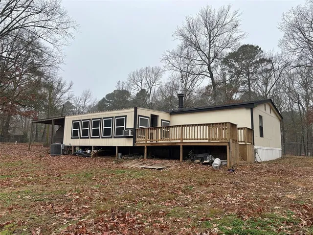 a front view of a house with a yard and balcony