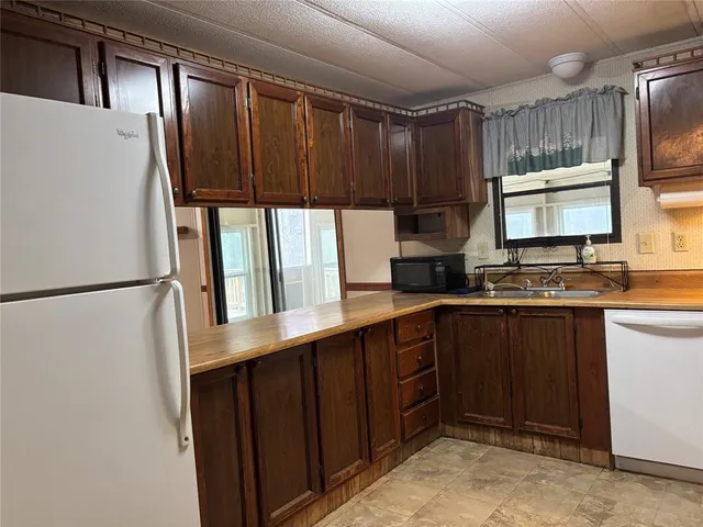 a kitchen with a refrigerator and a sink