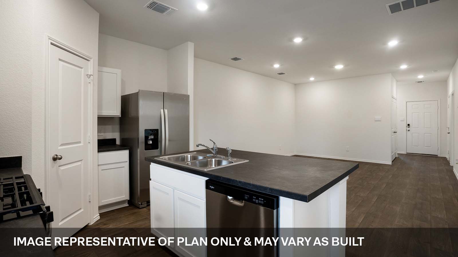 231 B Harrison Crossing Kyle, TX 78640 - Photo 3 of 19 a kitchen with stainless steel appliances granite countertop a sink a refrigerator and a stove