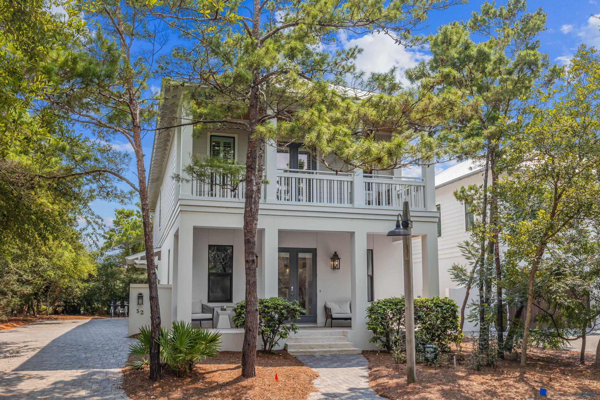 52 Pine Crest Circle Inlet Beach, FL 32461 - Photo 1 of 49 a front view of a house with plants and trees