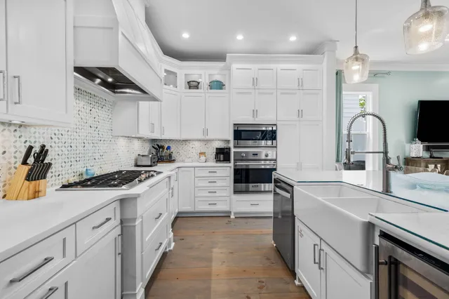 a kitchen with stainless steel appliances sink stove refrigerator and cabinets
