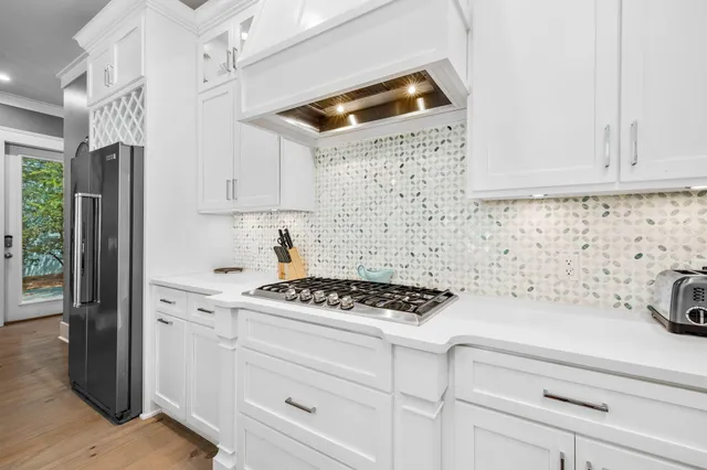 a kitchen with white cabinets and white appliances