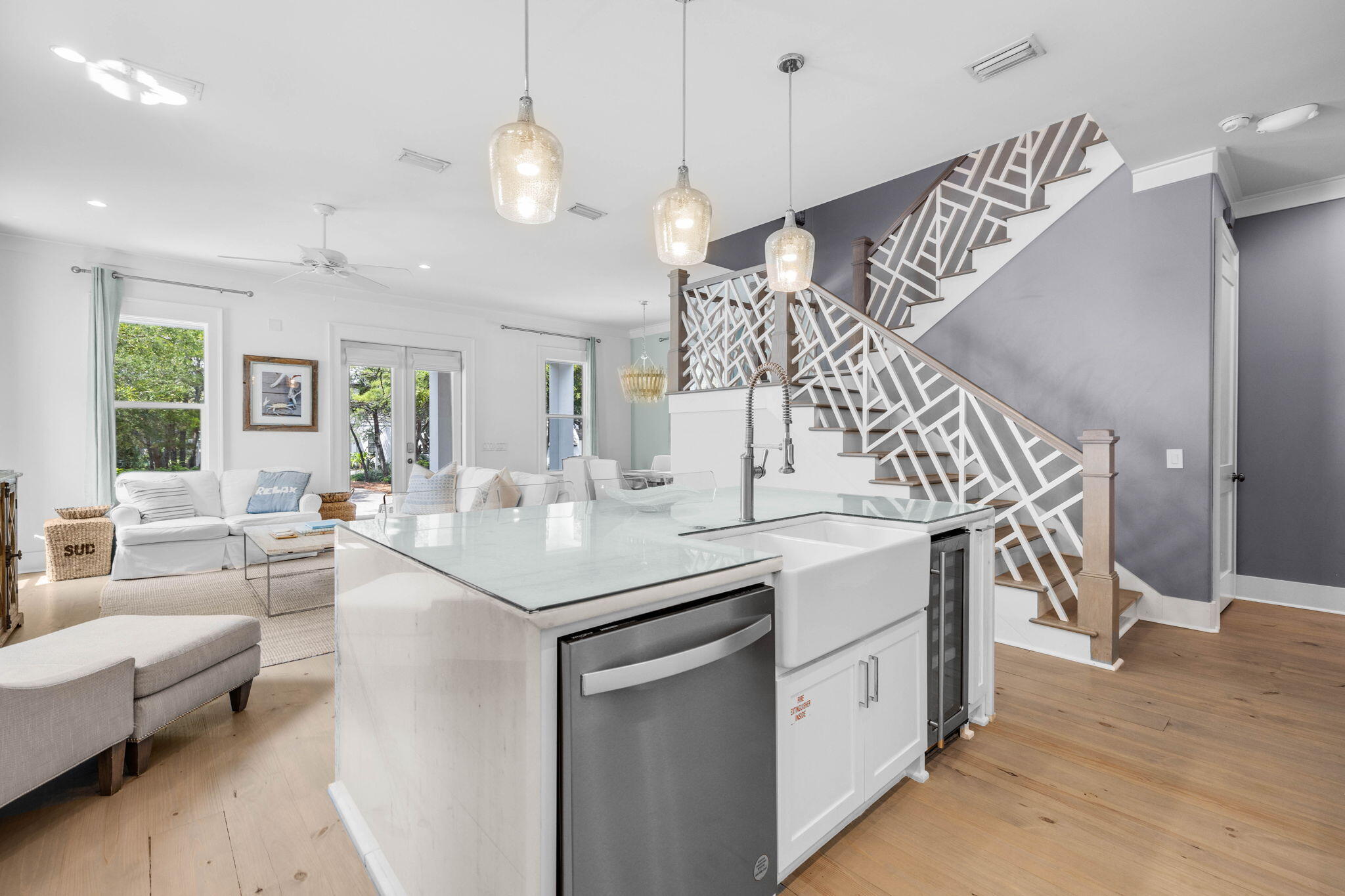 52 Pine Crest Circle Inlet Beach, FL 32461 - Photo 20 of 49 a kitchen with a sink dishwasher a dining table and chairs with wooden floor
