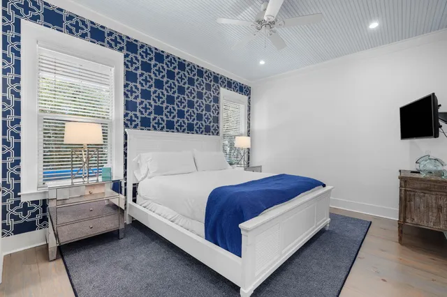 a bedroom with a bed and a flat screen tv