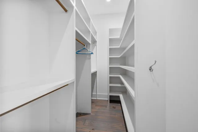 a view of staircase with white walls and empty racks