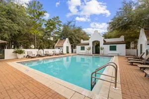 a view of a house with pool and sitting area