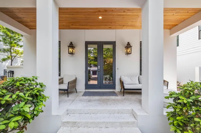 a living room filled with furniture and a potted plant