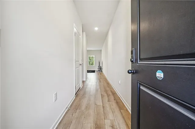 a view of a hallway with wooden floor