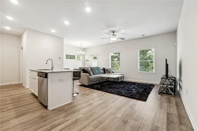 a living room with furniture and a wooden floor