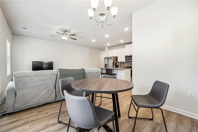 a view of a dining room with furniture and wooden floor