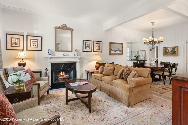 a living room with furniture a table and a fireplace